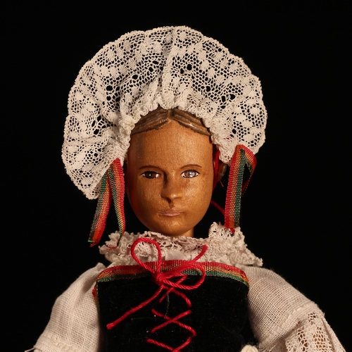 4060 - A Swiss carved wooden doll, probably produced in the Brienz Region, the carved wooden head with pain... 