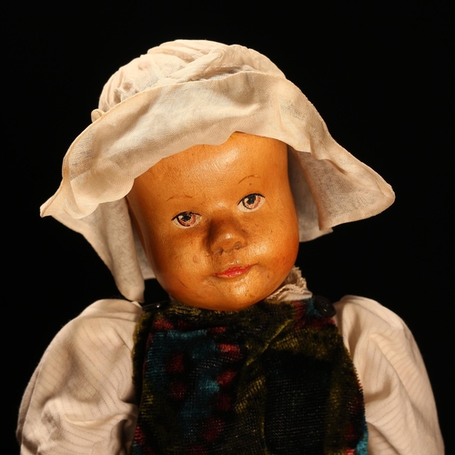 4061 - An early 20th century Swiss carved wooden head doll, probably produced in the Brienz Region by Huggl... 