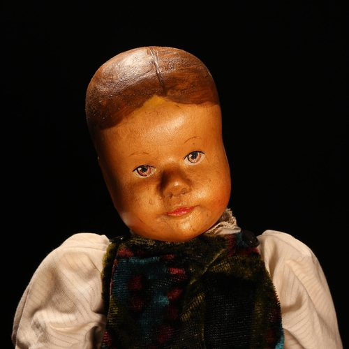 4061 - An early 20th century Swiss carved wooden head doll, probably produced in the Brienz Region by Huggl... 