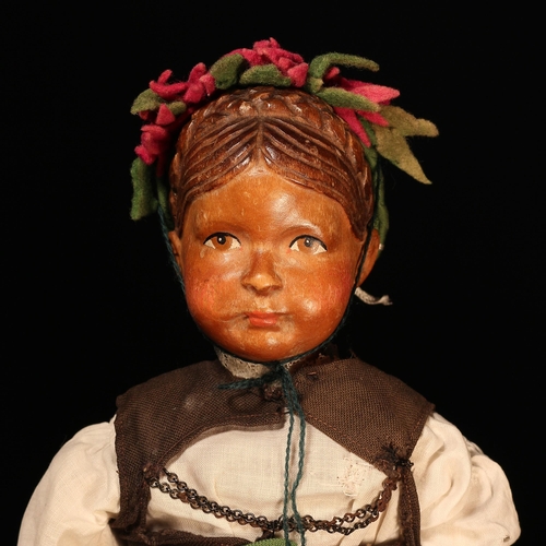 4062 - An early 20th century Swiss carved wooden head doll, probably produced in the Brienz Region by Huggl... 