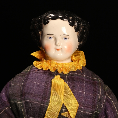 4073 - A 19th century glazed china shoulder head doll, the glazed head with painted features including blac... 