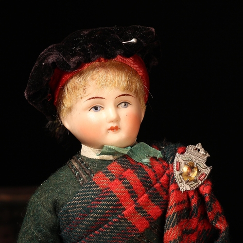 4081 - A bisque head and partially stuffed cloth bodied costume doll, the bisque head with painted features... 