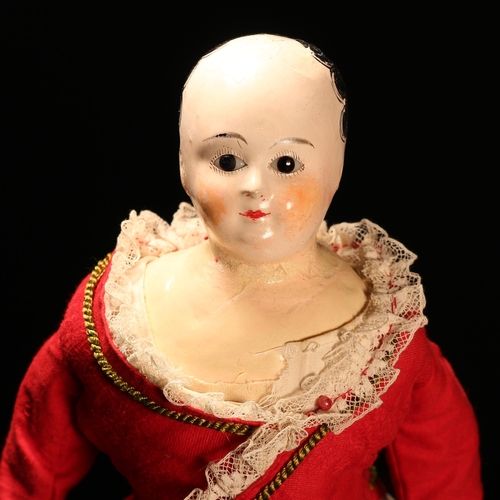 4089 - A 19th century papier-mâché shoulder head doll, the papier-mâché shoulder head inset with fixed brow... 