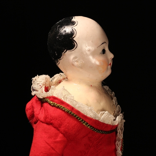 4089 - A 19th century papier-mâché shoulder head doll, the papier-mâché shoulder head inset with fixed brow... 