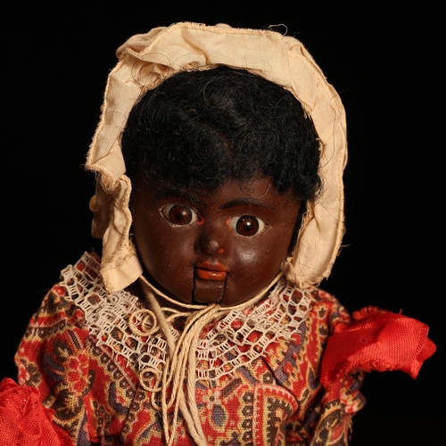 4090 - An early 20th century painted composition black shoulder head 'automaton' type doll, the painted com... 