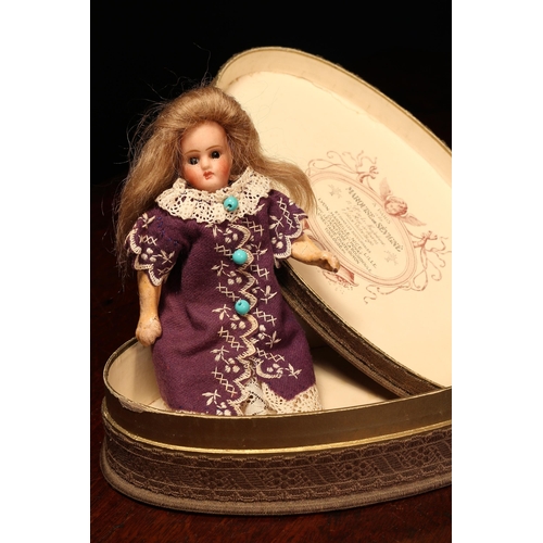 4091 - A bisque head and jointed painted composition doll, of small proportions, the bisque head with inset... 