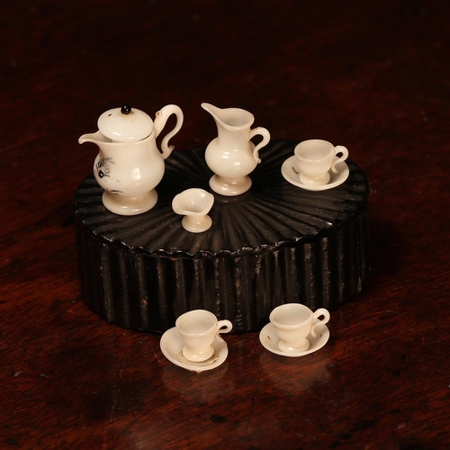 4100 - A mid 19th century miniature dolls milk glass tea service, comprising teapot, milk jug, sugar bowl a... 