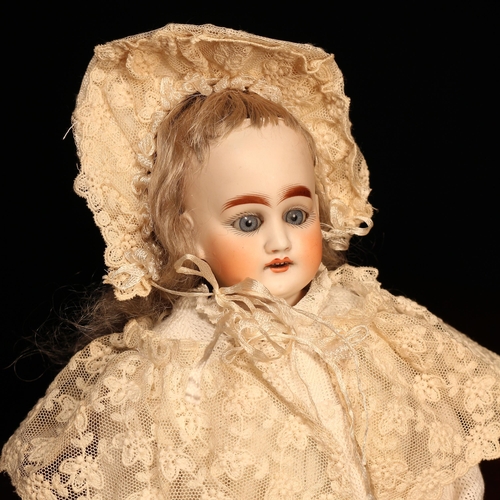 4110 - A bisque shoulder head doll, the bisque shoulder head with weighted sleeping blue glass eyes, painte... 