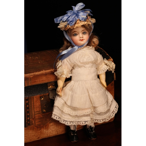 4111 - A late 19th century French bisque head Bébé doll, of small proportions, the bisque head with inset f... 