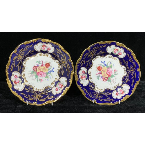 13 - A pair of Coalport shaped circular cabinet plates, the central field flanked by three shaped cartouc... 