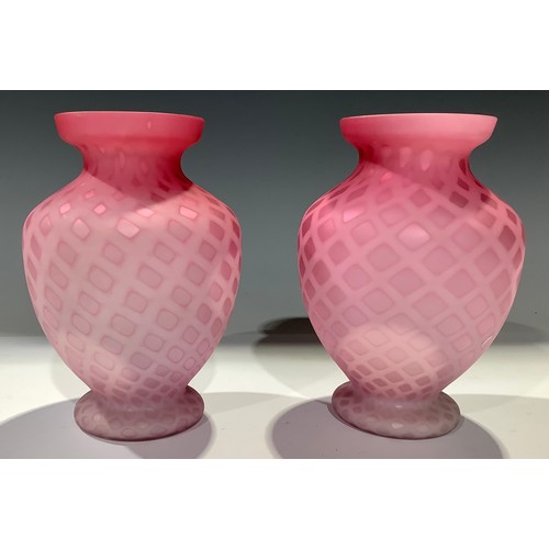 38 - A pair of Victorian pink satin glass ovoid pedestal vases, lattice pattern, 15cm