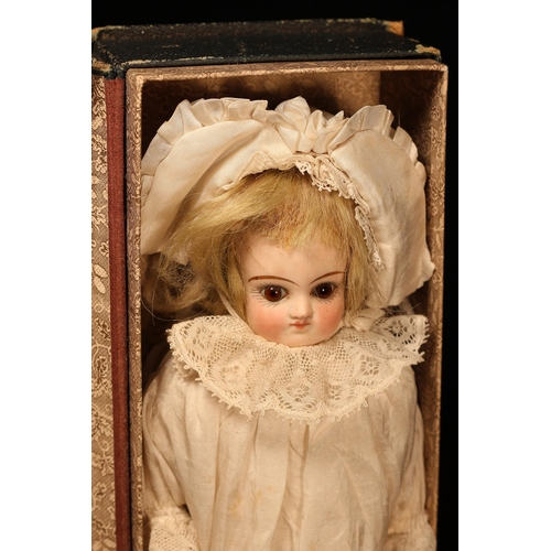 4120 - A bisque shoulder head doll, the bisque shoulder head inset with fixed brown glass eyes, painted fea... 