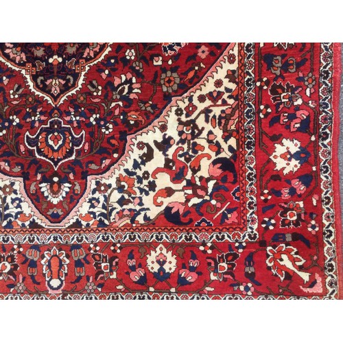 175 - A Persian Tabriz rug, knotted with a central lotus-form medallion within navette-shaped field of sty... 