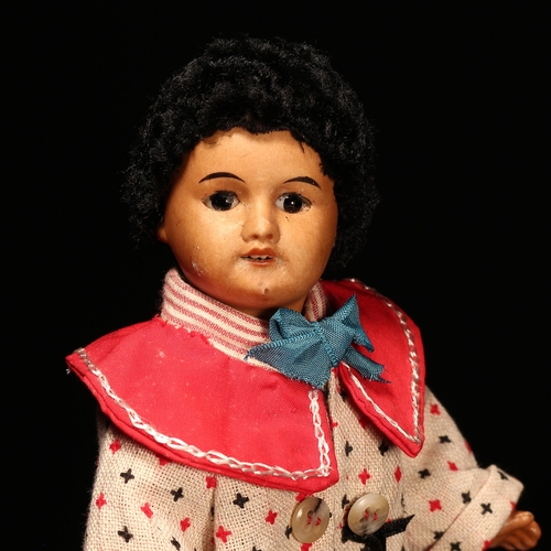 4130 - A French bisque head and painted composition black doll, the painted bisque head inset with fixed br... 