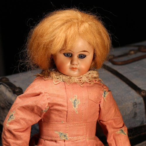 4131 - A bisque shoulder head doll, the bisque shoulder head inset with fixed blue glass eyes, painted feat... 