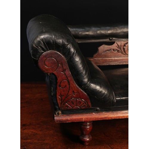 4136 - A late 19th/early 20th century buttoned-back dolls chaise longue, of small proportions, black leathe... 