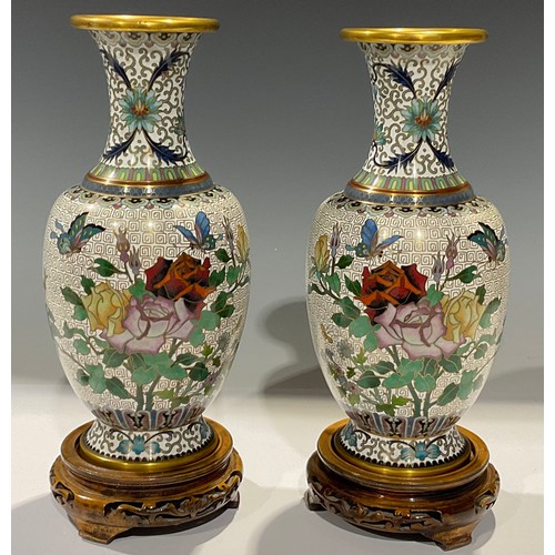 315 - A pair of Chinese cloisonne ovoid vases, decorated in polychrome with roses and butterflies, hardwoo... 