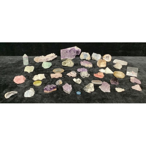 325 - An unpolished amethyst crystal fragment, others smaller; other quartz, fluorite, etc unpolished crys... 