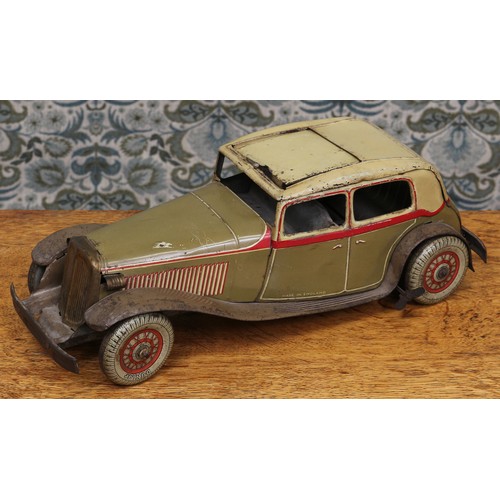 6275 - An early 20th century tinplate and clockwork saloon car, the lithographed tin body in olive drab wit... 