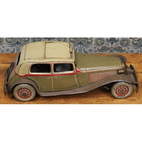 6275 - An early 20th century tinplate and clockwork saloon car, the lithographed tin body in olive drab wit... 