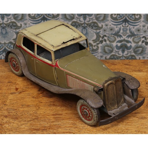 6275 - An early 20th century tinplate and clockwork saloon car, the lithographed tin body in olive drab wit... 