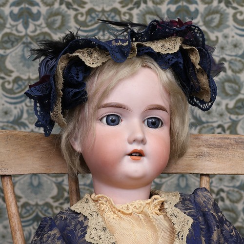 6282 - An Armand & Marseille (Germany) bisque head and ball jointed painted composition bodied doll, the bi... 