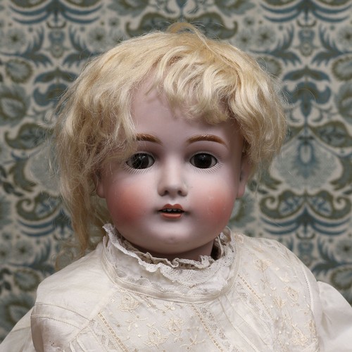 6284 - A German bisque head and ball jointed painted composition bodied doll, the bisque head with weighted... 