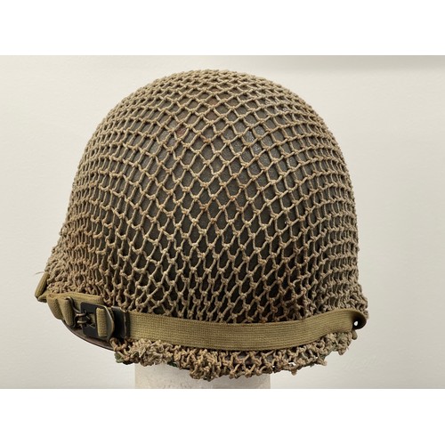 2113 - WW2 US M1 Helmet with swivel bale chinstrap. Rear seam. Heat stamp number 117B. Fitted with a postwa... 