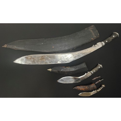 2247 - Three Kukri Knives: one very large example with 750mm long blade. Overall length 885mm. Complete wit... 