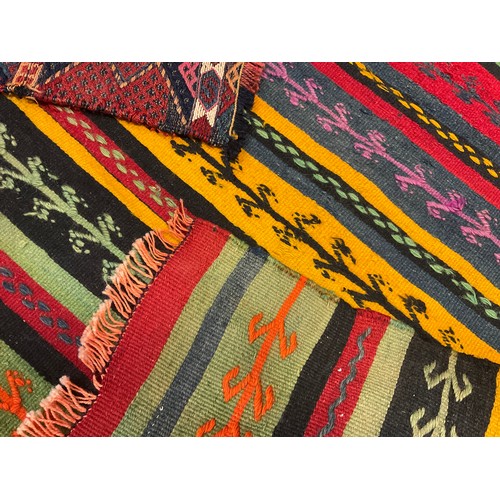 51 - Rugs and carpets - a Turkish Kilim rug, hand-knotted in bands of varying width in bright tones of or... 