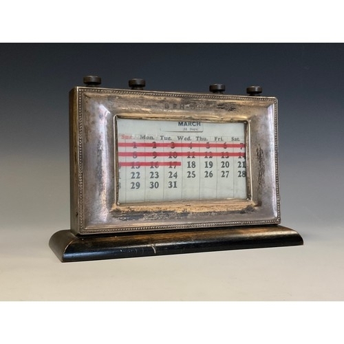 19 - A George VI silver rectangular desk calendar, beaded border, 21.5cm wide, Birmingham 1938