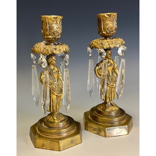 20A - A pair of 19th century gilt bronze figural candle lustres, each cast as a pastoral beauty gathering ... 