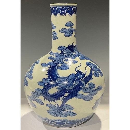 12 - A Chinese bottle vase, decorated in underglaze blue with dragon, 34cm high