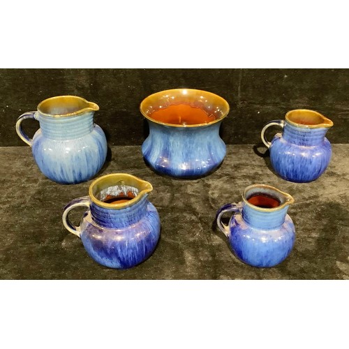 34 - A graduated set of three Denby Danesby Ware Electric Blue jugs, the largest 18cm high; another jug; ... 