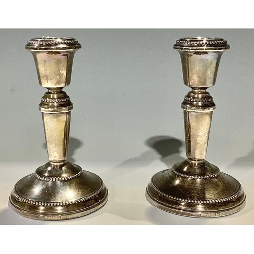 66 - A pair of Elizabeth II silver candlesticks, Birmingham 1962, 11cm high