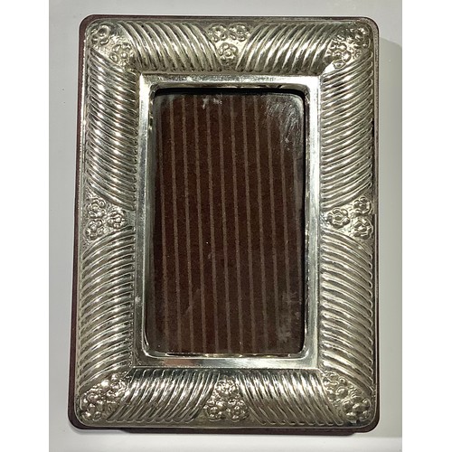 76 - A silver photograph frame, 11cm high