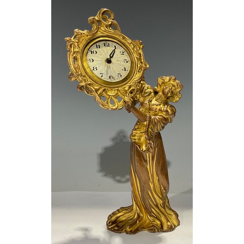 93 - An Art Nouveau gilt metal timepiece, modelled as a maiden wearing long flowing dress, 23.5cm high