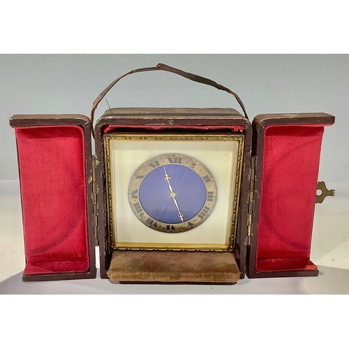 98 - An early 20th century travelling timepiece, blue guilloche enamel dial, Roman numerals on gilt metal... 