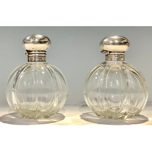 150 - A pair of Edwardian silver mounted fluted globular scent bottles, Birmingham 1903