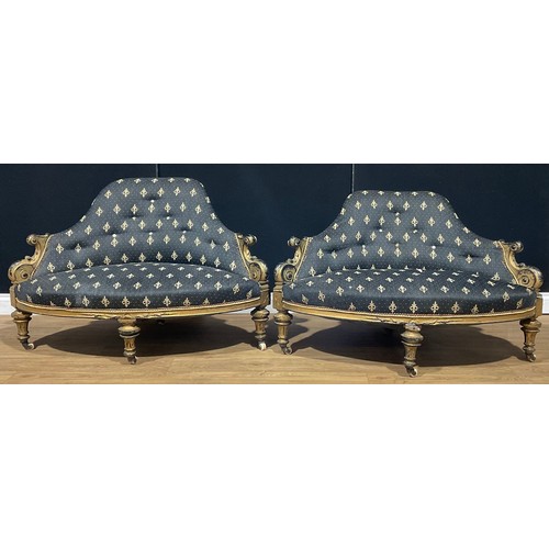 103 - A pair of Victorian gilt ebonised conversation proportion drawing room chairs, 74cm high, 124cm wide... 