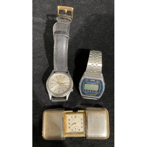 550 - A Seiko five day/date wristwatch; a Casio alarm chronograph; a slide purse watch