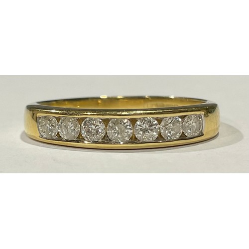 563 - An 18ct gold seven stone diamond ring, channel set, size U/V, 4g, boxed