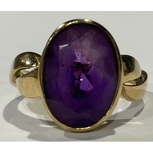 566 - A 9ct gold ring, set with a single faceted oval amethyst stone, size P, 5g