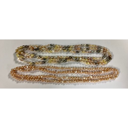 569 - A triple strand cultured freshwater pearl necklace, comprising natural, pink, grey and yellow pearls... 