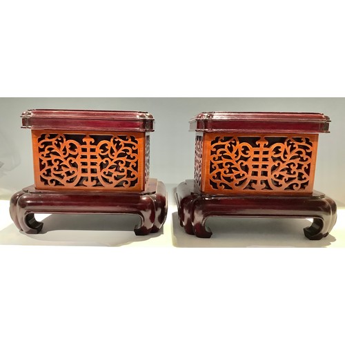 587 - A pair of Chinese rounded rectangular hardwood stands, 20.5cm high