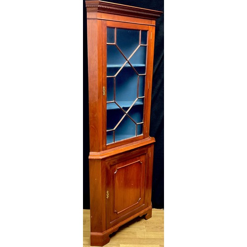 102A - A George III design mahogany floor standing corner display cabinet