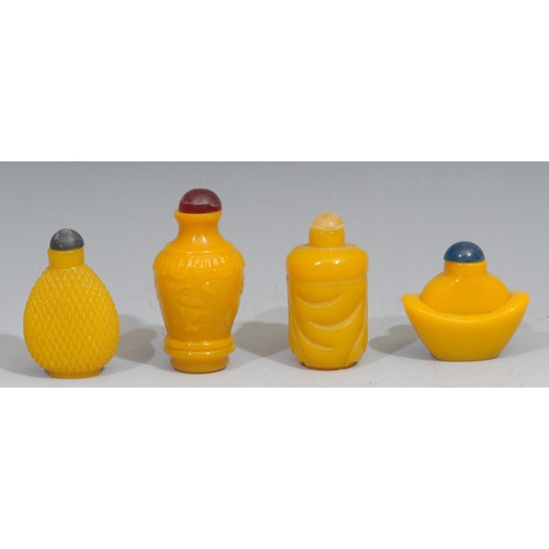 183 - A Chinese yellow glass snuff bottle, moulded with characters and lotus lappets, 8cm high; others (4)