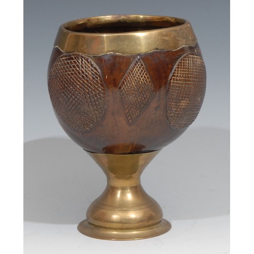 22 - A 19th century brass mounted coconut cup, decorated with alternating hobnail roundels and lozenges, ... 