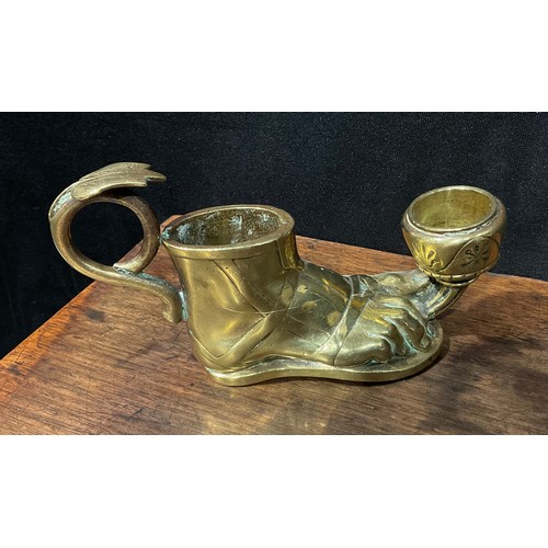 257 - A late 19th century brass candlestick, in the Grand Tour manner, as a sandaled foot, with vesta hold... 