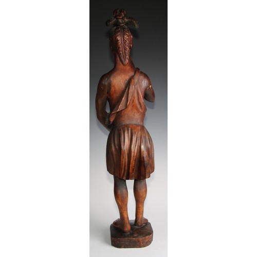 34 - A 19th century carved tobacconists advertising figure as a native American, standing wearing feather... 